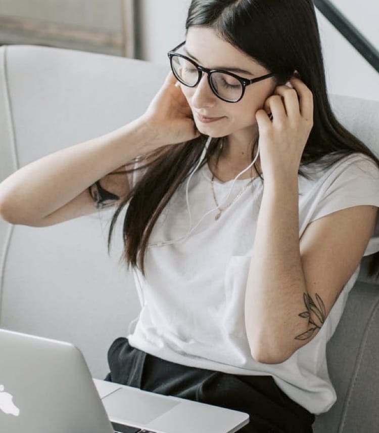 Image of woman listening to music with headphones on.